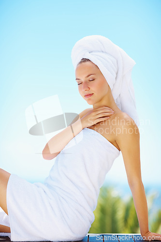 Image of Peace, woman and spa towel outdoor with wellness, skincare and health treatment with blue sky. Luxury, rest and zen of calm female person on vacation with body care and hotel for vacation and travel