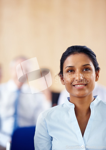 Image of Businesswoman, smile and listen to presentation at audience, conference or seminar in boardroom. Indian person, female manager and formal fashion with excitement for speaker, discussion or panel