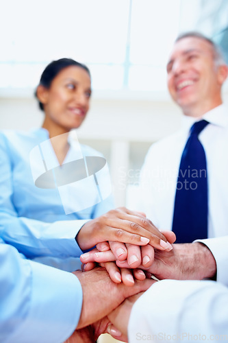 Image of Happy business people, hands together and meeting in teamwork, motivation or collaboration at office. Group of employees piling for community, diversity or support in trust or unity at workplace