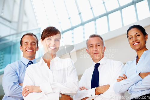 Image of Portrait, smile and business people with arms crossed, confident or support with coaching, corporate training or professional. Face, group or manager with employees, solidarity or low angle with joy