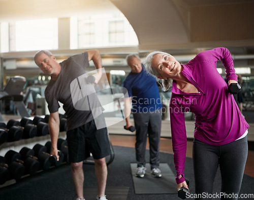 Image of Senior fitness club, stretching and people with dumbbells at gym for training, wellness or exercise. Class, workout and elderly men with personal trainer for weightlifting, support or bodybuilding