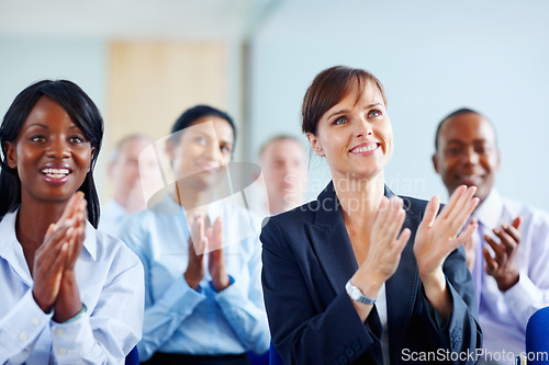 Image of Businesspeople, success and applause for presentation at seminar, trade show or conference in New York. Diverse group, staff or crowd with smile, happy or clapping in excitement for speaker for pride