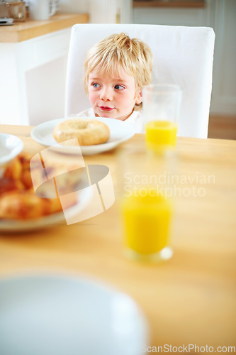 Image of Kid, breakfast and bagel at home in the morning with food, smile and happy from eating. Family, dinner table and hungry young child with meal for health and nutrition in a house with orange juice