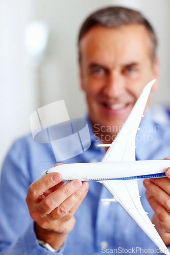 Image of Hands, travel and model airplane with a businessman in the office for a global or international trip. Corporate, transport or journey and a happy professional employee with a toy vehicle for flight