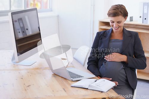 Image of Happy business woman, pregnant and office with laptop in joy for motherhood at workplace. Female person or employee touching stomach or tummy with smile for pregnancy by computer desk in maternity