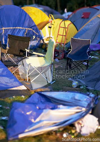 Image of Tents, trash and litter at an outdoor music festival or event for a celebration party or social gathering. Summer, campsite and trash with untidy camping gear, chairs or cooler boxes on the ground