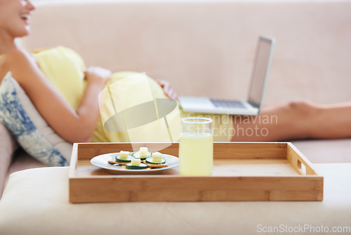 Image of Pregnant woman, food or laptop on sofa with healthy, nutrition or wellness for lunch or snack in living room. Person, meal or brunch and technology on couch for remote work, relax or internet at home