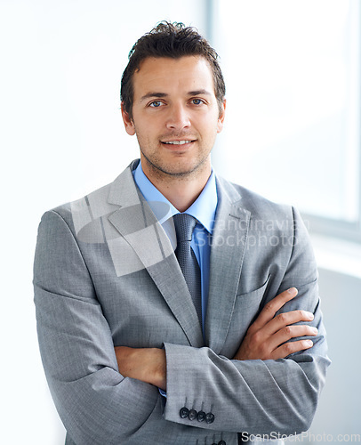 Image of Portrait, arms crossed and business man in company, corporate office or workplace pride. Face, professional employee and confident lawyer in suit, attorney or consultant working at law firm in Spain