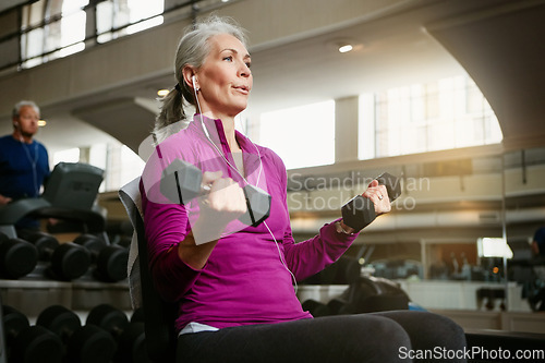 Image of Senior fitness, dumbbell or old woman at gym for training, wellness or cardio with earphones, music or exercise. Weightlifting, bodybuilding and elderly female person at sports center for arm workout