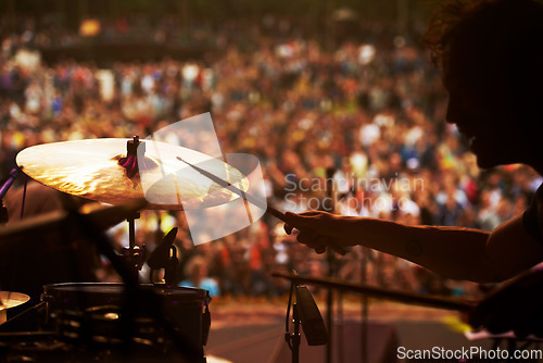 Image of Drummer, music and crowd at stage, concert or musician in performance at festival or event with fans. Playing, rock or man on drums in a metal band with audience listening to beat, sound or show