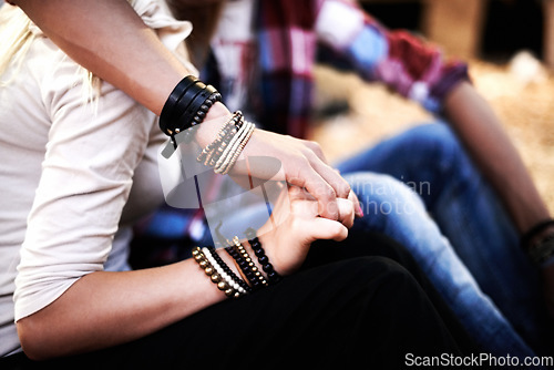 Image of Love, date and a couple holding hands at a music festival outdoor together closeup for romance or bonding. Party, concert or event with a man and woman in the audience or crowd for a carnival show