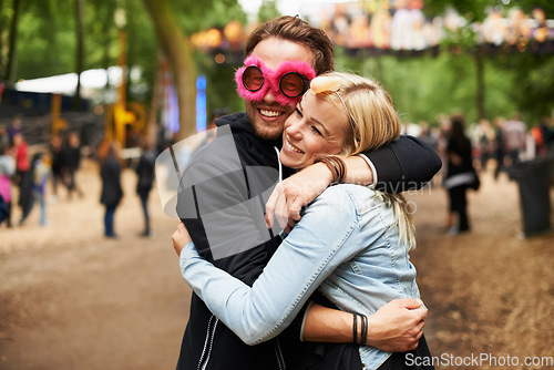 Image of Happy couple, hug and outdoor festival for love, care or support at crowded party, DJ event or music park. Man and woman smile in embrace, affection or trust for festive celebration or summer break