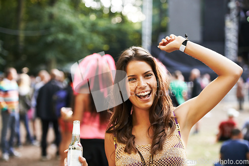 Image of Music, festival and portrait of woman at a concert, stage and celebration with alcohol, bottle or beer at event. Happy, girl and dancing at party with audience, crowd and excited fan at techno rave