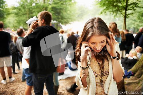 Image of Music festival, event and woman outdoor with phone call, conversation and noise from crowd at a party. Contact, person and confused by loud, sound or listening to smartphone for communication at rave