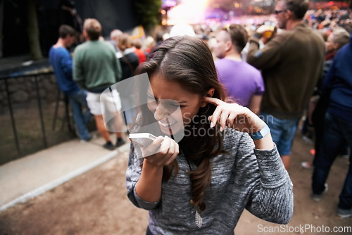 Image of Music festival, event and woman outdoor with phone call, conversation and noise from concert, crowd or party. Contact, person and confused by loud, sound or listening to smartphone and lost at a rave