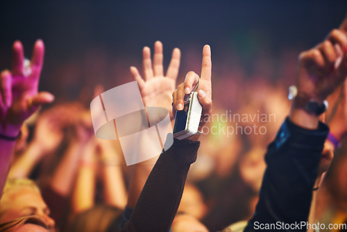 Image of Hands, camera and a crowd of people at a music festival closeup with energy for freedom or celebration. Party, concert or event with an audience at a rock or musical performance or nightlife show