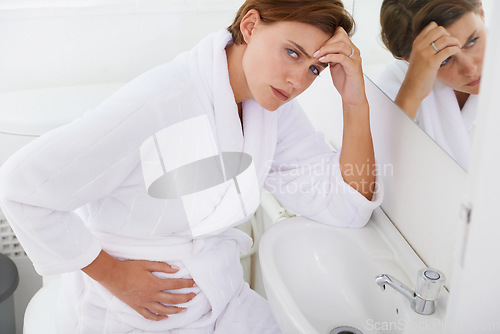 Image of Nausea, pregnant woman and morning sickness in bathroom, unhappy and hand on stomach. Mirror reflection, moody and frustrated with illness, pregnancy and struggling with migraine pain on sink