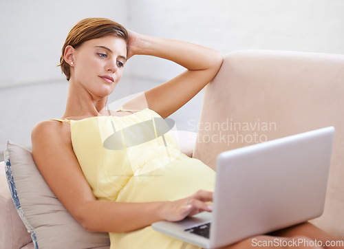 Image of Thinking, pregnant and woman on laptop in house living room for childcare website, information and reading. Vision, ideas and relax person on home sofa with technology, research and pregnancy blog