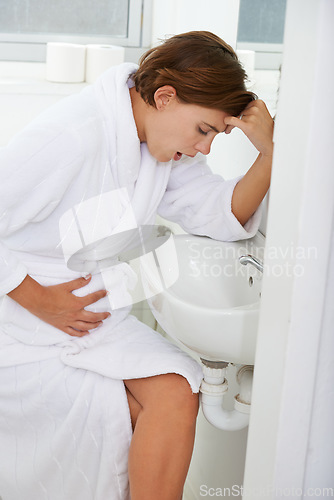 Image of Vomiting, pregnant woman and morning sickness in bathroom, nausea and hand on stomach. Mirror reflection, moody and frustrated with illness, pregnancy and struggling with migraine pain on sink