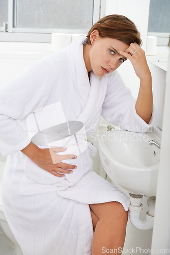 Image of Nausea, pregnant woman and morning sickness in bathroom, unhappy and hand on stomach. Mirror reflection, moody and frustrated with illness, pregnancy and struggling with migraine pain on sink