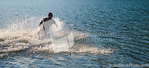 Image of Triathlon athlete starting swimming training on lake