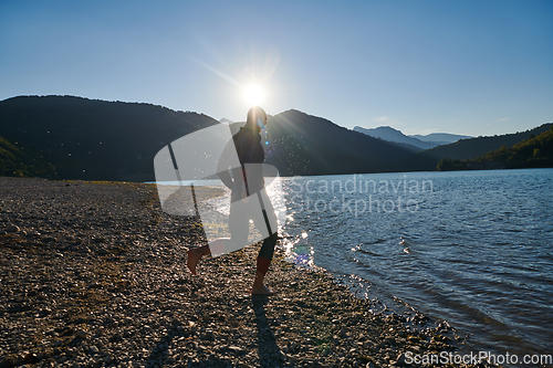 Image of Triathlon athlete starting swimming training on lake