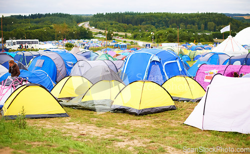 Image of Tents, field and music festival outdoor for dancing event in forest for party celebration, rave weekend on vacation. Campsite, land and crowd for concert dj disco accommodation, park trip in nature