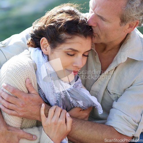 Image of Couple, forehead kiss and hug with love, peace or happy on holiday with gratitude for partnership. Mature, man and woman relax in embrace outdoor on vacation together or show affection and care