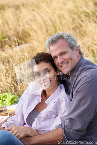 Image of Mature couple, portrait and picnic in park for a date with love, care or support in marriage. Happy, man and woman relax on grass with food, nature and hug in celebration on holiday or vacation