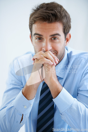 Image of Happy, office and portrait of business man at desk with confidence, pride and ambition. Corporate, professional employee and face of entrepreneur with ideas for company, career and job in workplace