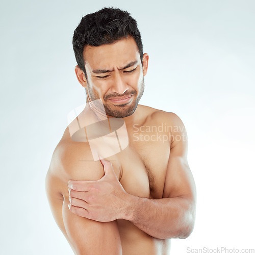 Image of Shoulder pain, stress and fitness with man in studio for arthritis, tension or nerve problem on white background. Arm, injury and face of Asian model with osteoporosis, fibromyalgia or sport accident