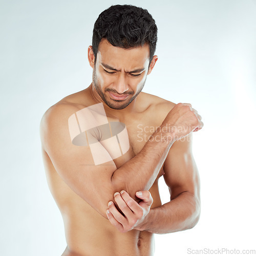 Image of Arm pain, stress and asian fitness man in studio with muscle tension, arthritis or inflammation on white background. Elbow, injury and Japanese male model with fibromyalgia, osteoporosis or emergency