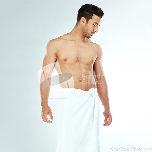 Image of Body, cleaning and thinking asian man in a towel in studio for beauty, hygiene and care on grey background. Chest, relax and muscular Japanese model with glowing skin grooming results after shower