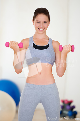 Image of Woman, confident or portrait with dumbbells in gym, health wellness or fitness for weight loss with exercise. Young person, pride or face with hand weights for muscle training results or strong body