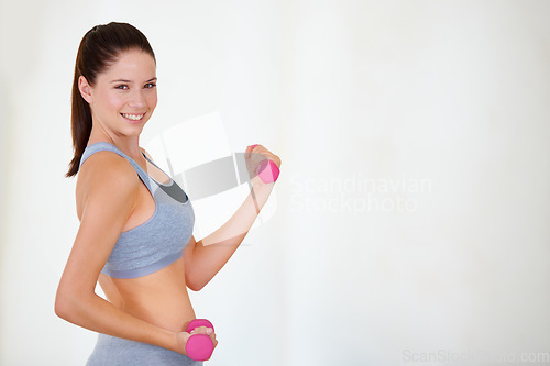 Image of Woman, flex or portrait with dumbbells in studio, health wellness or fitness action for weight loss with exercise. Young person, pride and face with hand weights for tone muscle by white background