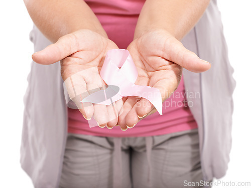 Image of Studio person, breast cancer ribbon and hands show bow awareness icon, kindness or activism support. Health wellness care, recognition campaign or closeup model giving compassion on white background