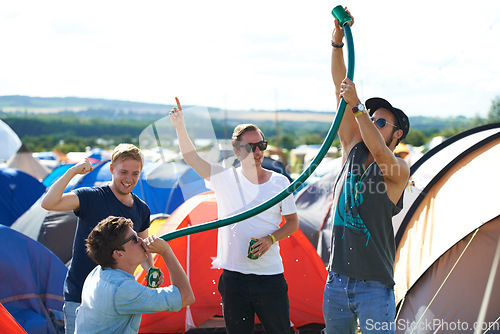 Image of Alcohol, festival or drunk friends drinking together, beer beverage or outdoor social event. Summer music concert, party games celebration or excited people with freedom, hose funnel or pipe tube