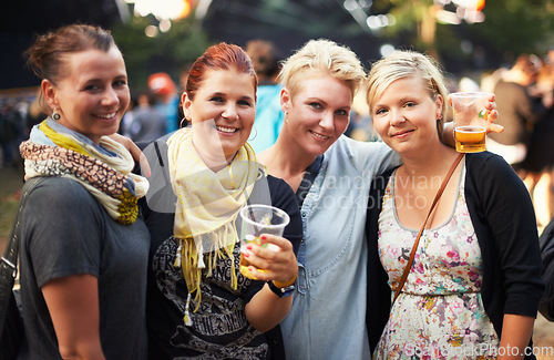 Image of Portrait of group of women at music festival with beer, smile and hug in nature together. Drink, celebration and friends relax at outdoor party with freedom, adventure and happy people at concert.