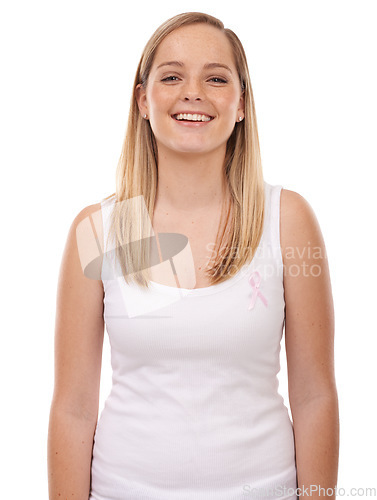 Image of Studio portrait, breast cancer ribbon and happy woman with survivor wellness, awareness campaign or support. Happiness, health sign and girl smile for disease recognition movement on white background