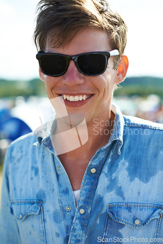 Image of Smile, portrait or happy man at outdoor music festival for concert, party or event in nature. Face, sunglasses or male person enjoying sound outside in sunshine at carnival in summer for celebration