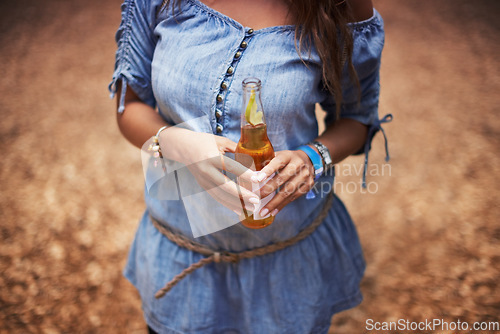 Image of Hands of woman at music festival with nature, beer and relax in woods for concert event. Alcohol, celebration and girl at outdoor party in freedom, adventure and person in park, forest or countryside