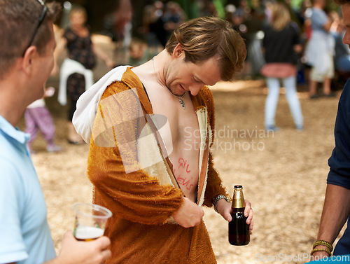 Image of Animal, costume and man with beer at festival in field with friends and drunk in summer on holiday. Person, drink and relax on vacation at concert or carnival with funny monkey suit and freedom