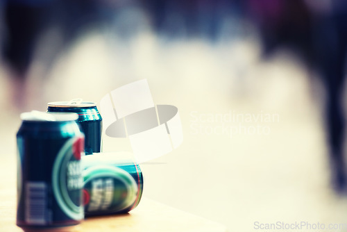Image of Space, blurred background and cans of beer closeup outdoor at a music festival for drinking or celebration. Party, product and alcohol with lager or ale at a carnival for the enjoyment of a beverage