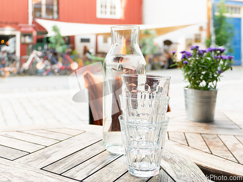 Image of Three glasses and a carafe with water