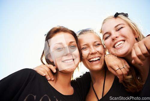 Image of Friends, portrait and women hug outdoor for travel, bond and having fun on vacation, break or trip. Face, smile and group or people embrace outside for reunion, weekend or holiday hangout on blue sky