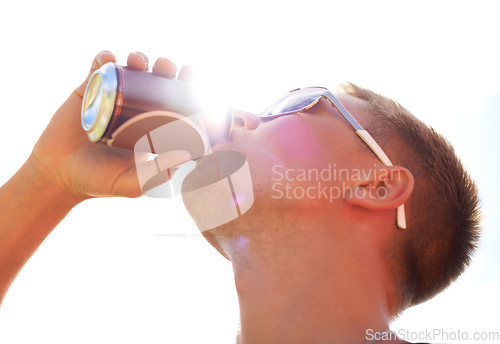 Image of Man, drinking and beer with sunlight outdoor for concert, event or music festival with sunglasses and lens flare. Person, alcohol and beverage in summer for relax, freedom and enjoyment with sunshine