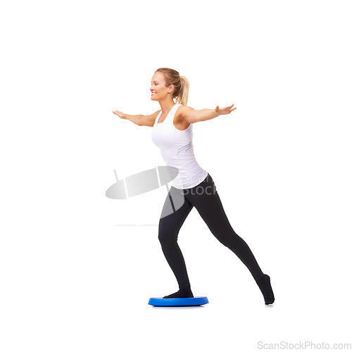 Image of Balance, health and smile with woman on disk in studio for workout, mindfulness or exercise. Wellness, challenge and training with person on white background for flexibility, fitness or aerobics