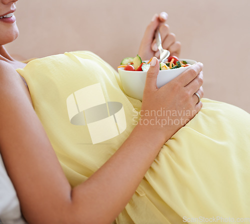 Image of Pregnant woman, salad and bowl on sofa for health, nutrition and wellness in living room of apartment. Person, fruit and happy on couch of lounge for relax, pregnancy and healthy diet with vitamins
