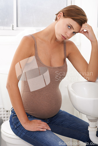 Image of Nausea, pregnant woman and morning sickness in portrait, bathroom and uncomfortable person. Exhausted, moody and frustrated with illness, pregnancy and struggling with migraine pain on basin