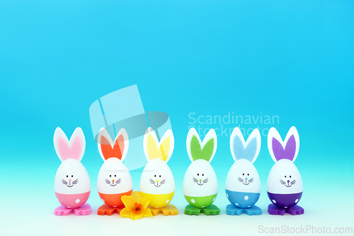 Image of Easter Bunny Rainbow Eggs with Spring Narcissus Flower